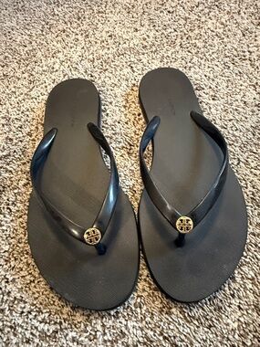 Tory Burch Black Flip Flops with Gold Logo Medallions